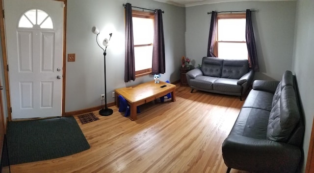 living room with light wood finished floors and baseboards