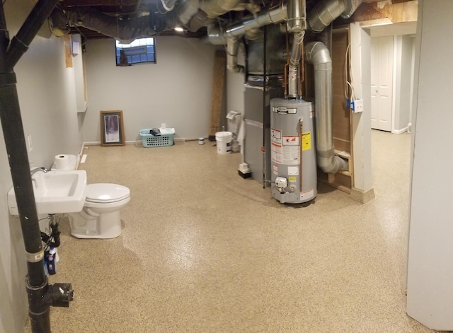 below grade area with gas water heater and a sink