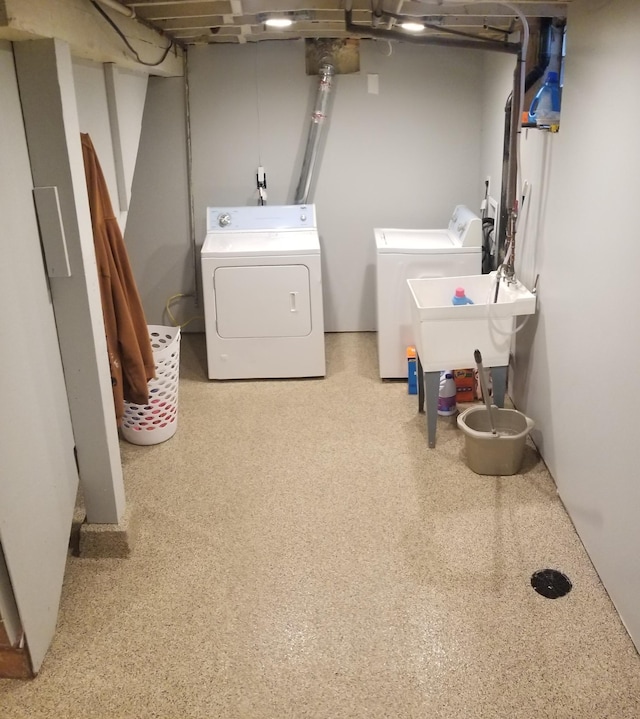 laundry room with washing machine and dryer, laundry area, and a sink