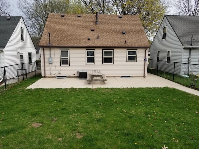 back of property with a patio, a yard, and a fenced backyard