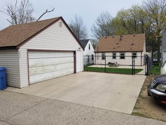 detached garage featuring fence