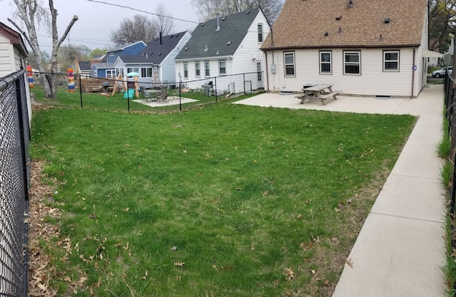 view of yard featuring a fenced backyard, a residential view, and a patio