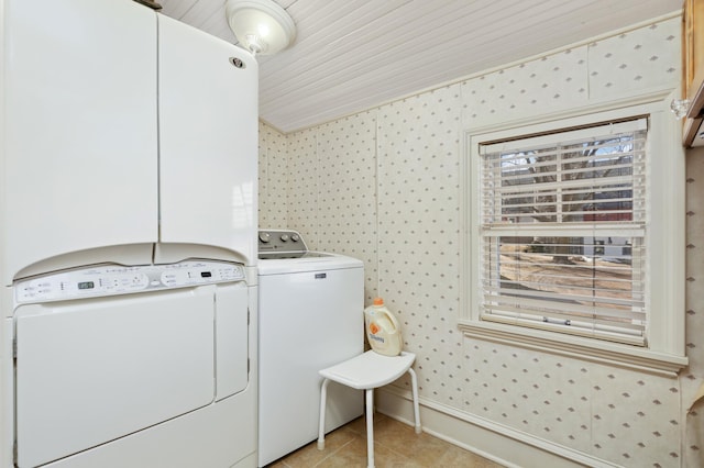 laundry area with baseboards, wallpapered walls, separate washer and dryer, and light tile patterned floors