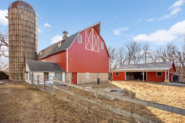 view of barn with fence