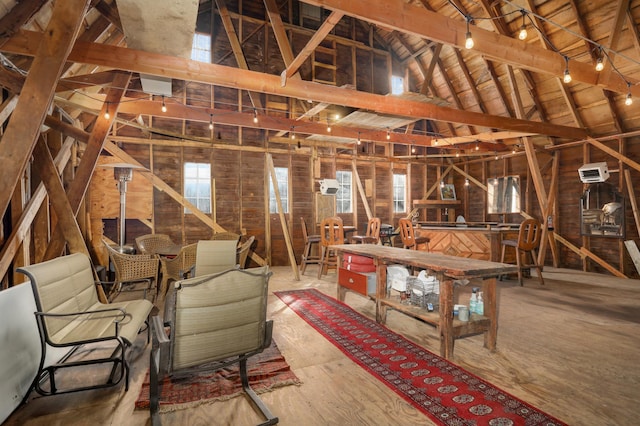 miscellaneous room with vaulted ceiling with beams