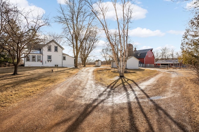 view of road featuring dirt driveway