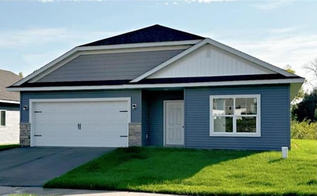 view of front of house with driveway, a garage, and a front lawn