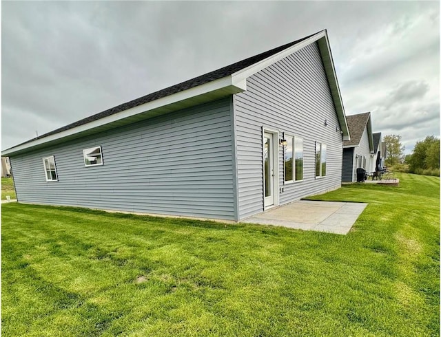 view of property exterior featuring a patio area and a yard