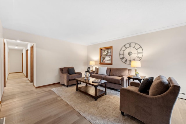 living area featuring light wood finished floors, visible vents, and baseboards