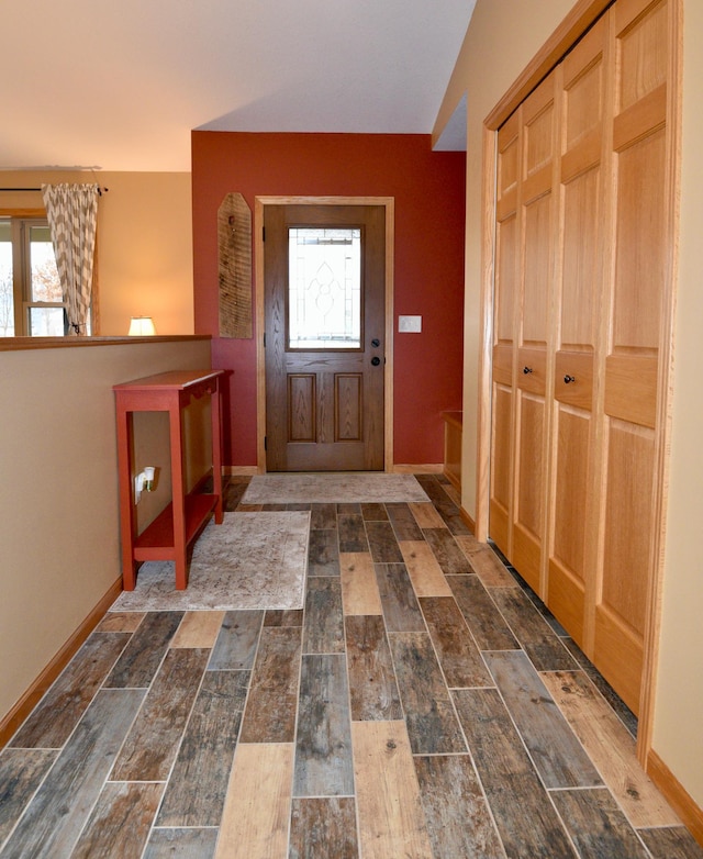 entrance foyer with dark wood finished floors, plenty of natural light, and baseboards