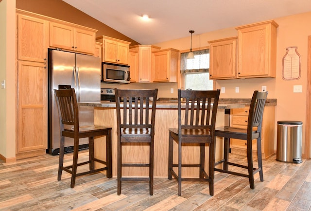 kitchen featuring light wood-type flooring, stainless steel appliances, and light brown cabinetry