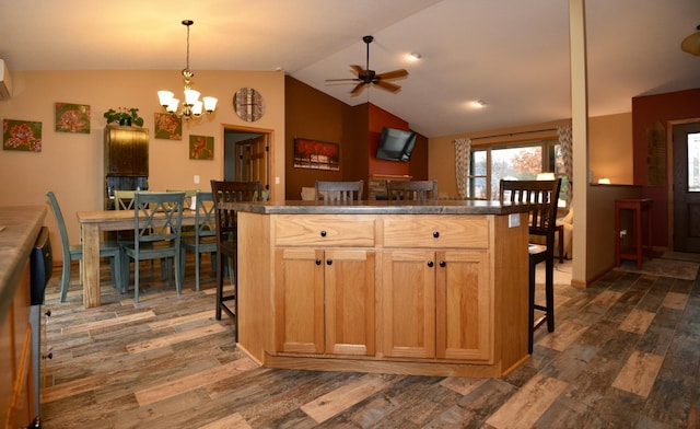 kitchen featuring lofted ceiling, a wall unit AC, dark wood finished floors, and a breakfast bar area