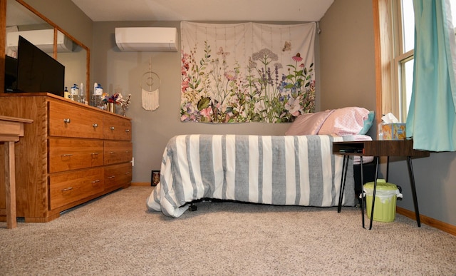 bedroom with a wall unit AC and baseboards