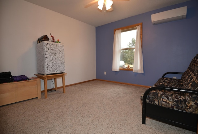 sitting room featuring a ceiling fan, an AC wall unit, and baseboards