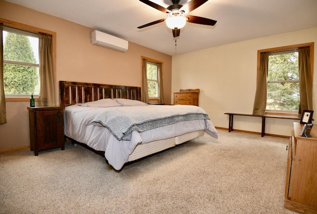 bedroom featuring light carpet, ceiling fan, a wall unit AC, and baseboards