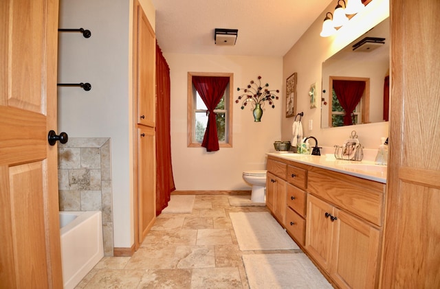 full bath featuring toilet, double vanity, baseboards, and a sink