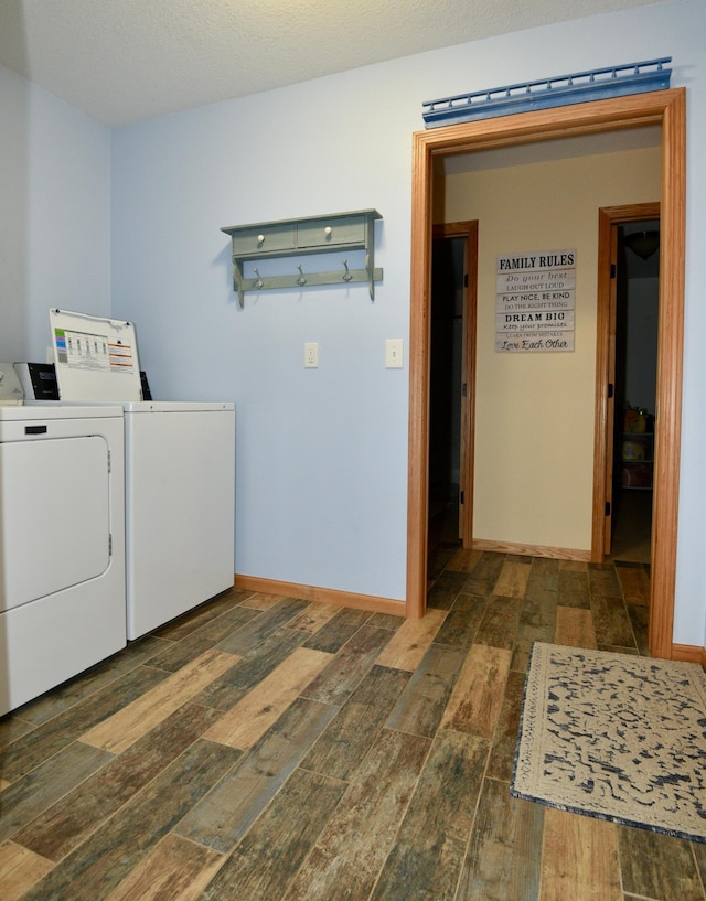 laundry room with baseboards, wood finished floors, and independent washer and dryer