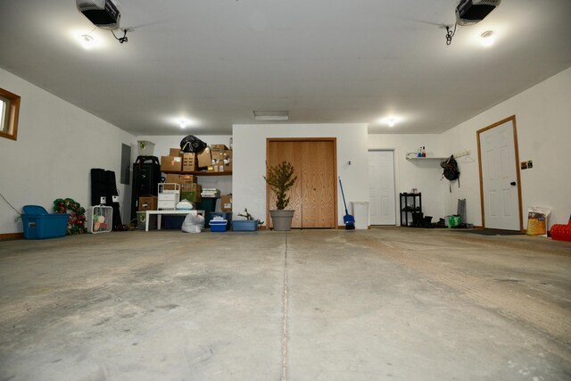 garage with electric panel and a garage door opener