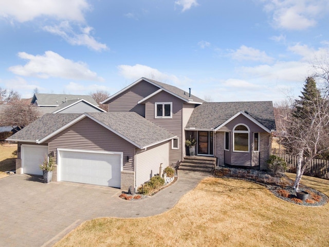 view of front of home featuring a garage, brick siding, driveway, roof with shingles, and a front lawn