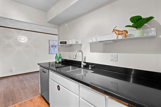 kitchen with open shelves, a sink, white cabinets, dishwasher, and light wood-style floors