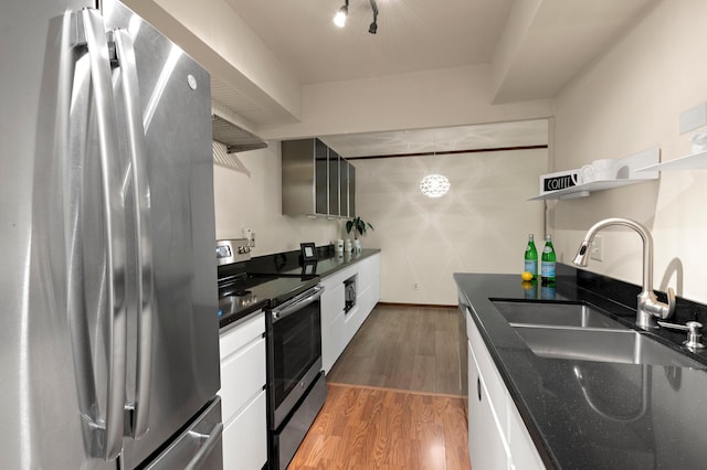 kitchen with stainless steel appliances, open shelves, a sink, light wood finished floors, and white cabinets