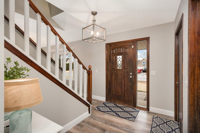 entryway featuring visible vents, stairs, baseboards, and wood finished floors