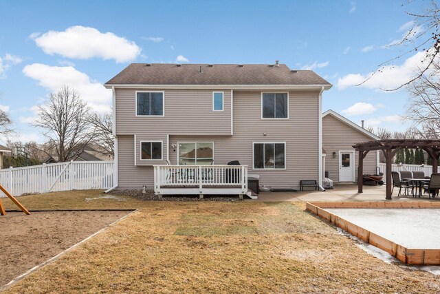 back of house featuring a patio, fence, a yard, a wooden deck, and a pergola