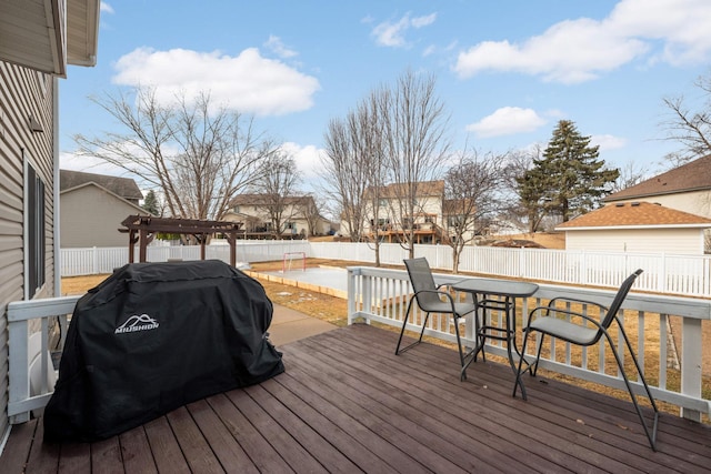 wooden deck with outdoor dining space, a fenced backyard, grilling area, and a pergola