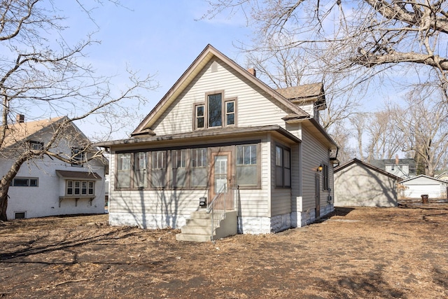 back of house with entry steps and a sunroom