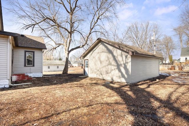 view of property exterior featuring a shingled roof