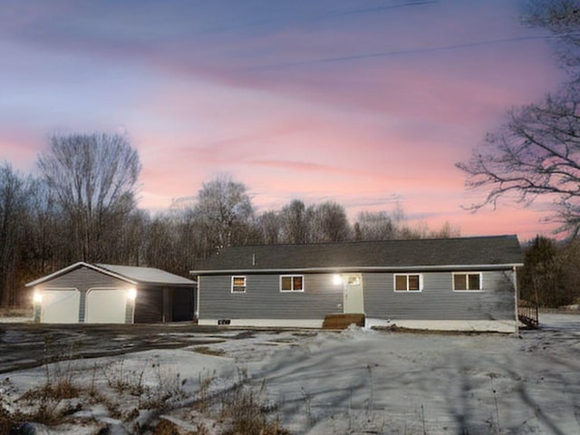 ranch-style house featuring a detached garage and an outdoor structure