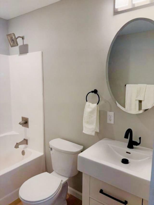 bathroom with toilet, vanity, and shower / bathing tub combination