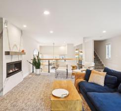 carpeted living area featuring recessed lighting, a fireplace, and stairway