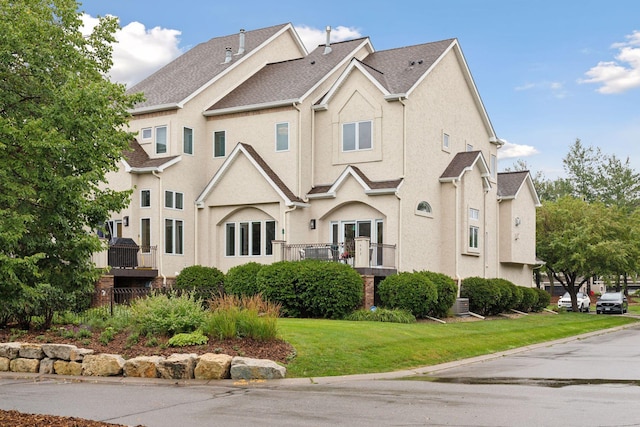 view of front of property with a front yard and stucco siding