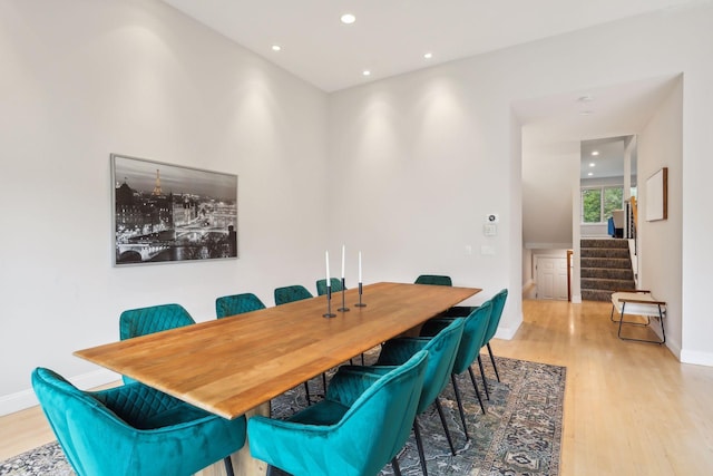 dining space featuring stairs, recessed lighting, wood finished floors, and baseboards