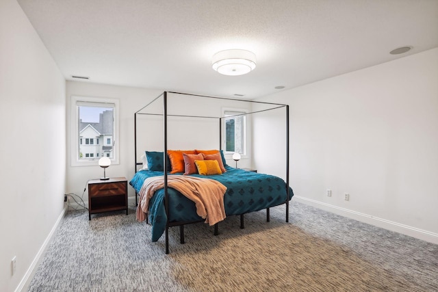 carpeted bedroom featuring baseboards