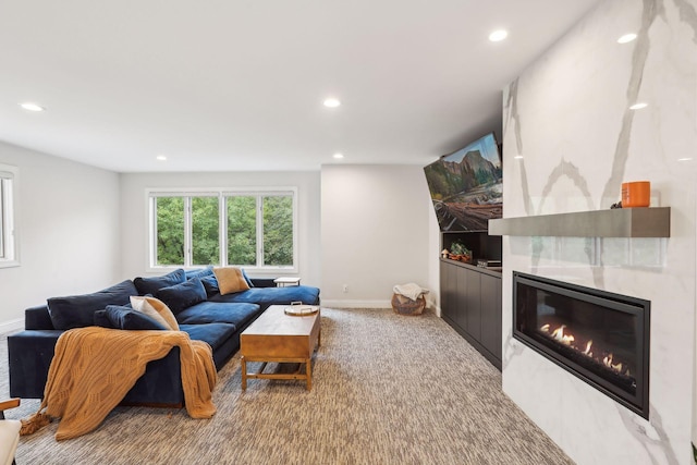 carpeted living room with recessed lighting, baseboards, and a tiled fireplace