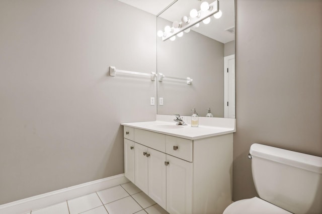 bathroom with visible vents, toilet, vanity, tile patterned flooring, and baseboards