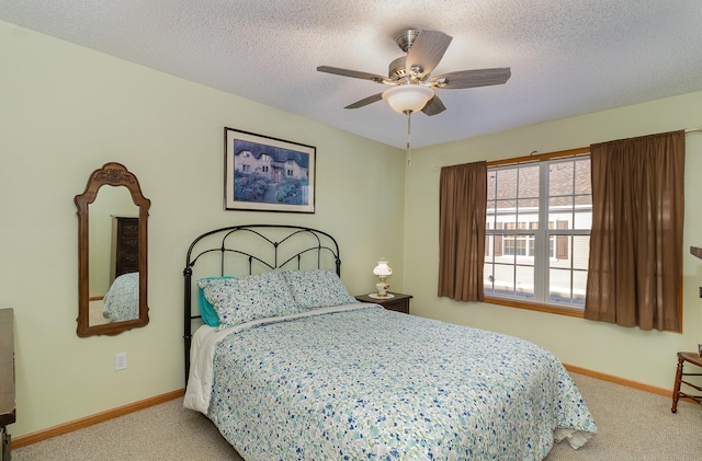 bedroom featuring a textured ceiling, baseboards, and carpet flooring