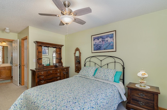 bedroom with light carpet, ceiling fan, and a textured ceiling