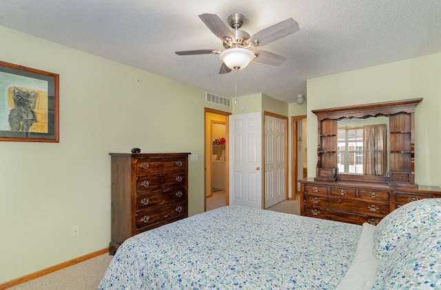 carpeted bedroom featuring baseboards, visible vents, and a textured ceiling