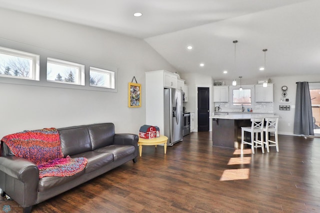 living room with lofted ceiling, dark wood-style flooring, and recessed lighting