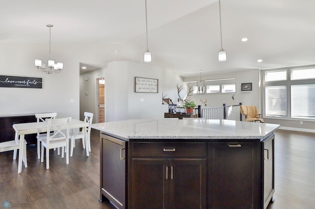 kitchen with dark wood-style floors, hanging light fixtures, dark brown cabinets, and vaulted ceiling