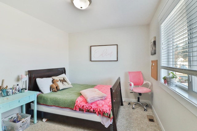 carpeted bedroom with visible vents and baseboards