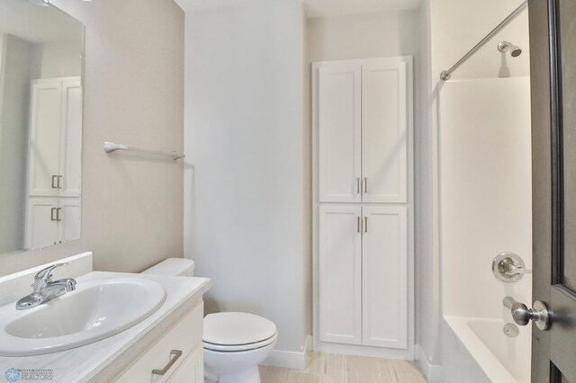 bathroom with toilet,  shower combination, and vanity