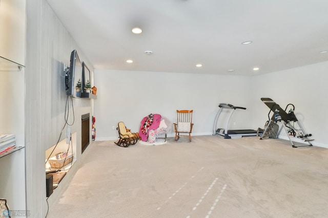 exercise area with baseboards, carpet floors, a fireplace, and recessed lighting