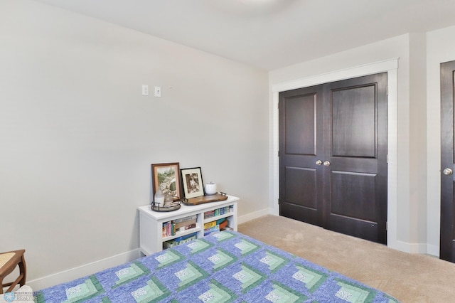 bedroom with carpet floors and baseboards