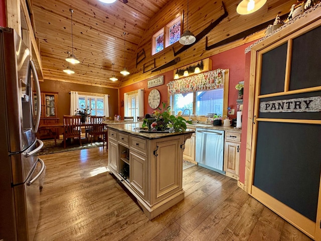 kitchen with wooden ceiling, hardwood / wood-style floors, stainless steel appliances, cream cabinetry, and pendant lighting