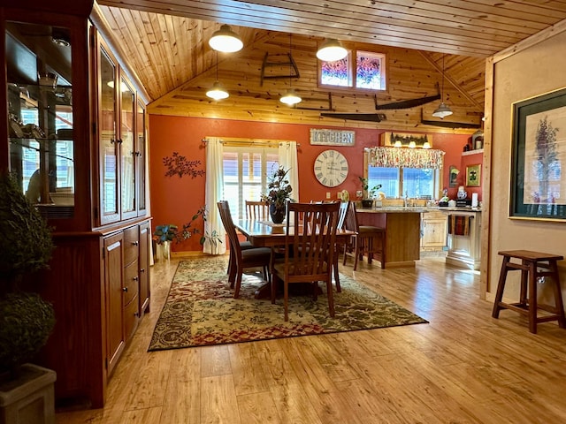 dining room featuring light wood-type flooring, wooden ceiling, high vaulted ceiling, and baseboards