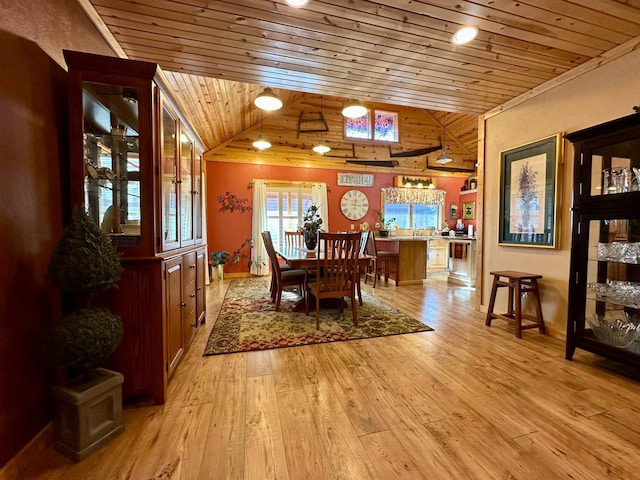 dining space featuring light wood-style floors, wooden ceiling, and vaulted ceiling